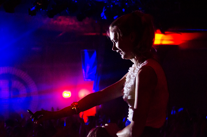 A fan enjoying a view of the show from the only slightly less hectic bar.