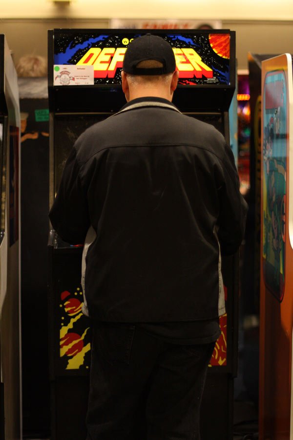 Eric Johnson plays Defender, a game he says was always very difficult. His favorite old-school game, however, is Moon Patrol, which was featured at the show.