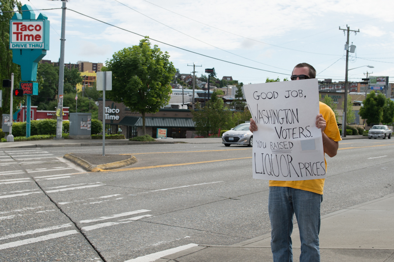 A man on Fauntleroy in West Seattle protests the newly enacted Washington state liquor law.