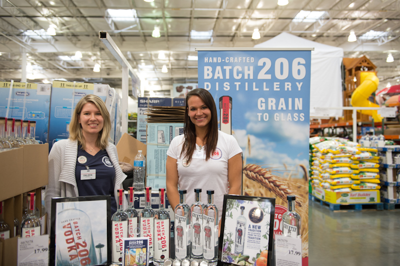 Two employees at Costco advertise the Batch 206 Distillery.