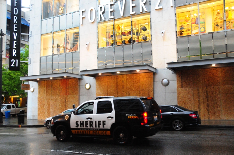 As the protests come to a close, storefronts are boarded off—both due to damage and as a preventive measure in case of additional violence.