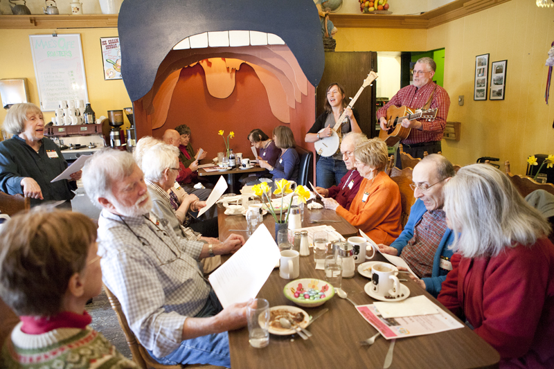 Volunteers from the Greenwood Senior Center bring a guitar and banjo, and serenade the 10 or so couples with Let It Be and This Land Is Your Land. Lyric sheets are passed out, and almost everyone sings along.