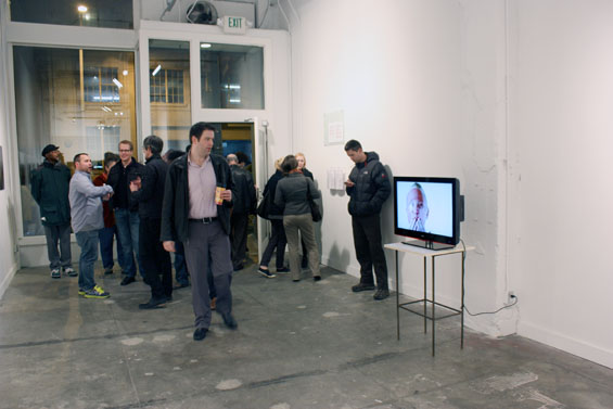 People gather in the Platform Gallery and are instantly drawn to Russell's video, which they watch with intrigue.
