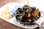 Meaty roasted Penn Cove mussels, popped open wide as catcher's mitts, are sunk in a lemony white wine sauce strewn with rosemary stalks.