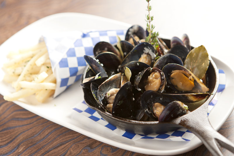 Meaty roasted Penn Cove mussels, popped open wide as catcher's mitts, are sunk in a lemony white wine sauce strewn with rosemary stalks.
