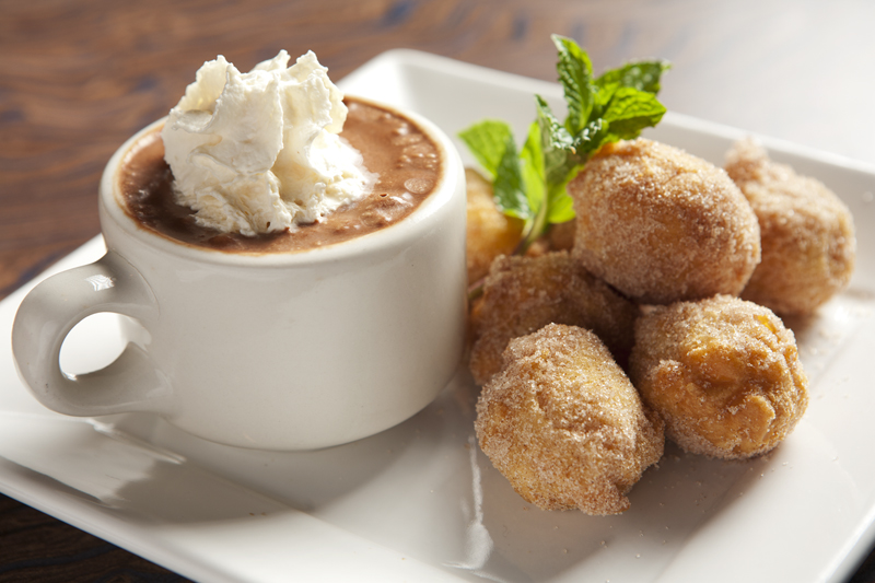 Tiny cinnamon-dusted doughnuts accompanied by a mug of chocolate sorbet capped with Bailey's whipped cream.