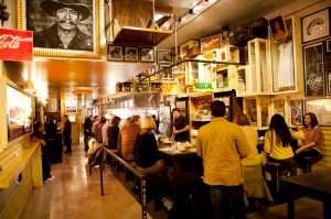 With its sleek bar and honeyed lighting, Mezcaleria Oaxaca's front room looks extraordinarily polished, even though it's furnished with more tchotchkes than auctioneers uncover in abandoned storage lockers.