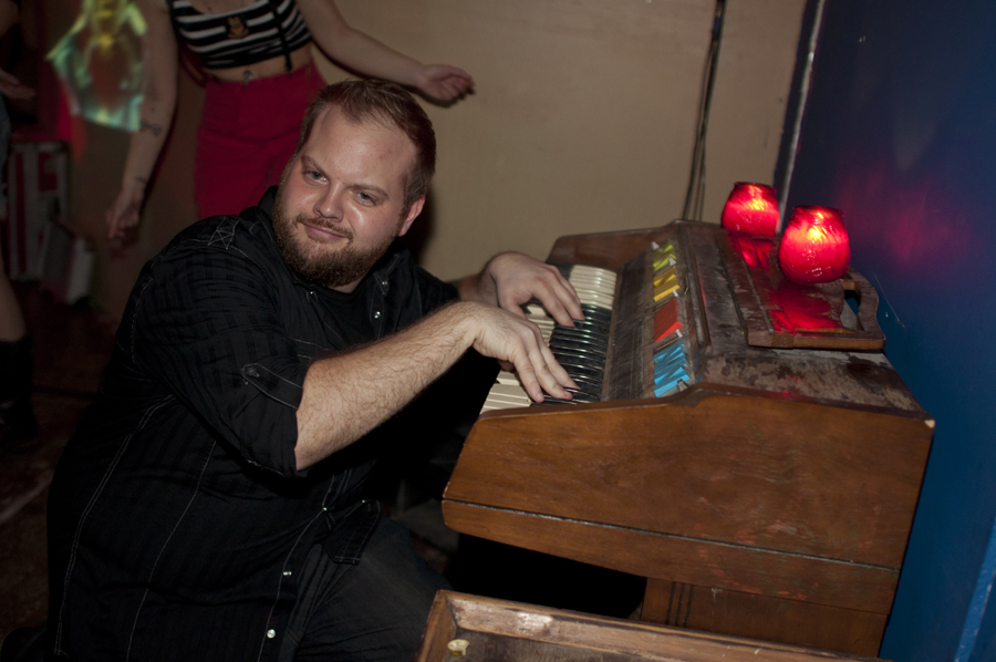 Feeling especially inspired by the music, this man played with the decorative organ in the room.