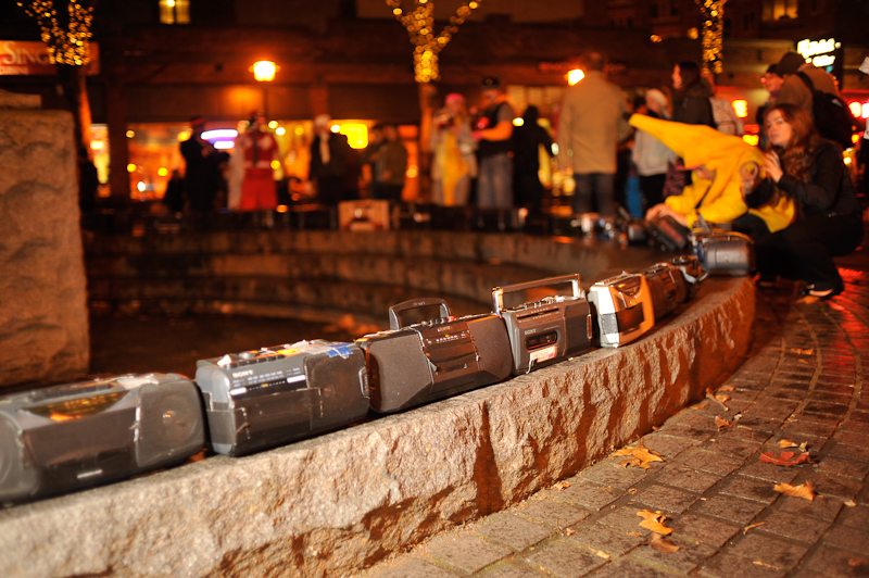 Clad in business attire and wielding boomboxes, hundreds of revelers romped around