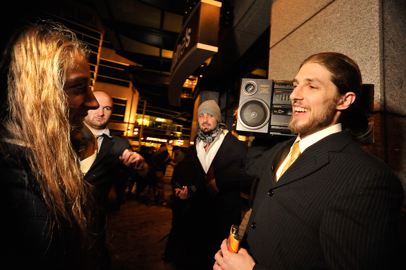 Clad in business attire and wielding boomboxes, hundreds of revelers romped around