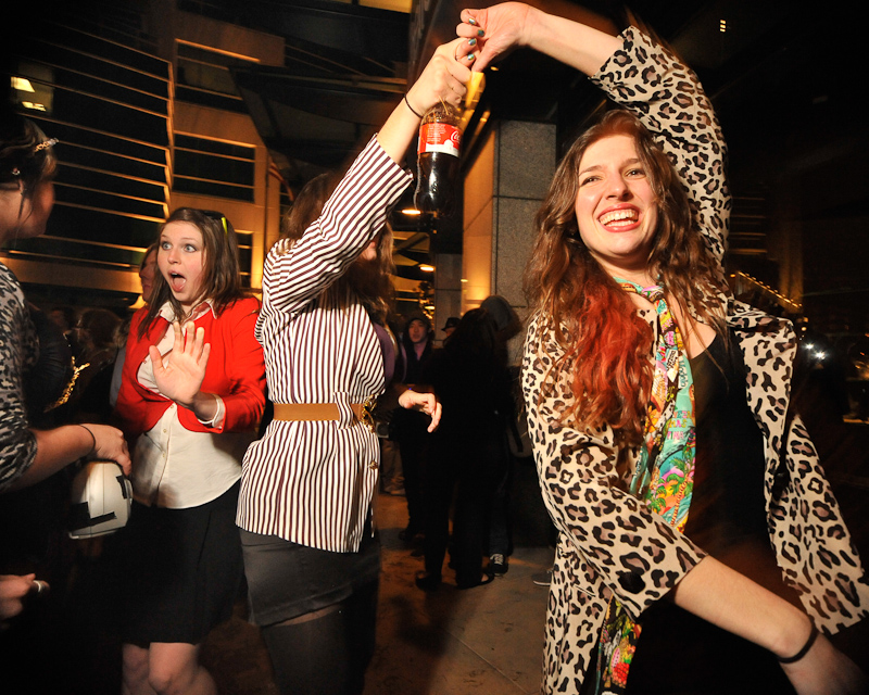Clad in business attire and wielding boomboxes, hundreds of revelers romped around