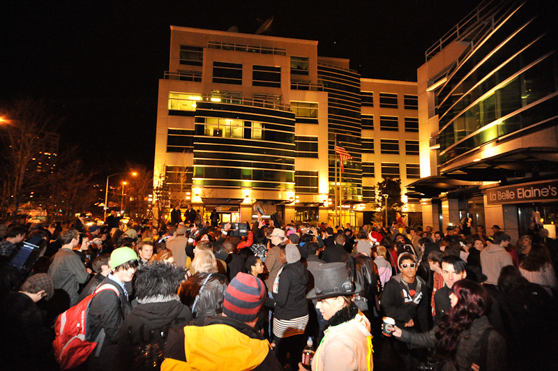 Clad in business attire and wielding boomboxes, hundreds of revelers romped around