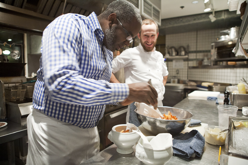 Executive Chef and Owner, Daisley Gordon plates up the French fries.
