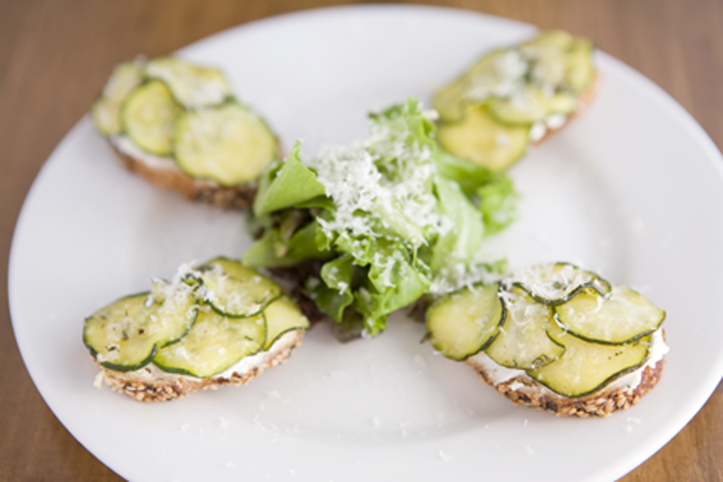 Spackled with goat cheese and topped withtranslucent ruffles of zucchini, the toasty tartines arepassable-plus