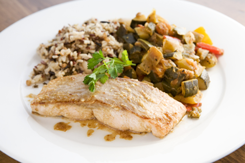 Filet of wild salmon fillet pan grilled, served with ratatouille and brown ricemedley.