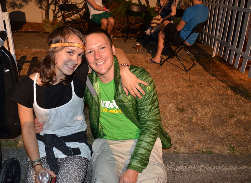 Sanna and Chris cuddle by the trash.