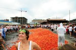 The group assembles around tens of thousands of tomatoes.