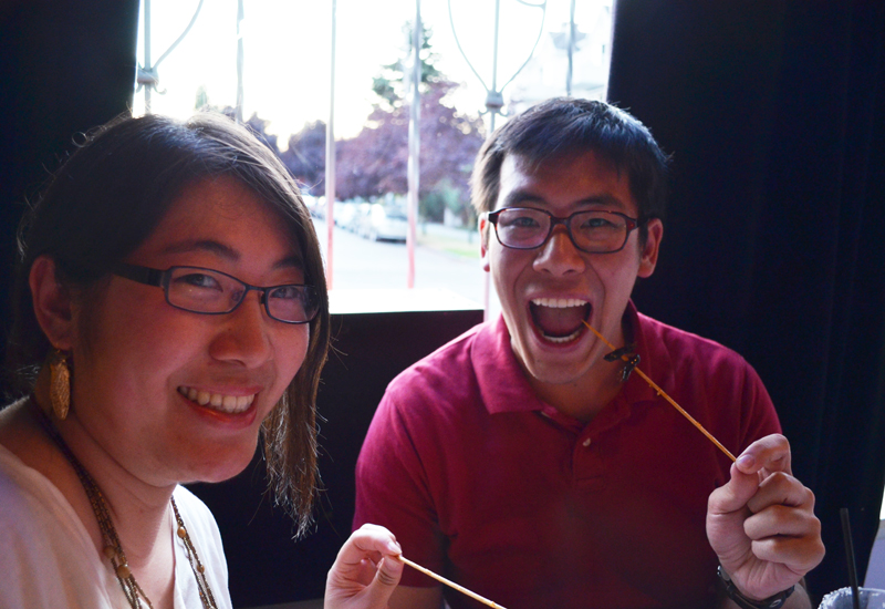 Stella and Calvin Yee enjoy their  locust appetizers.