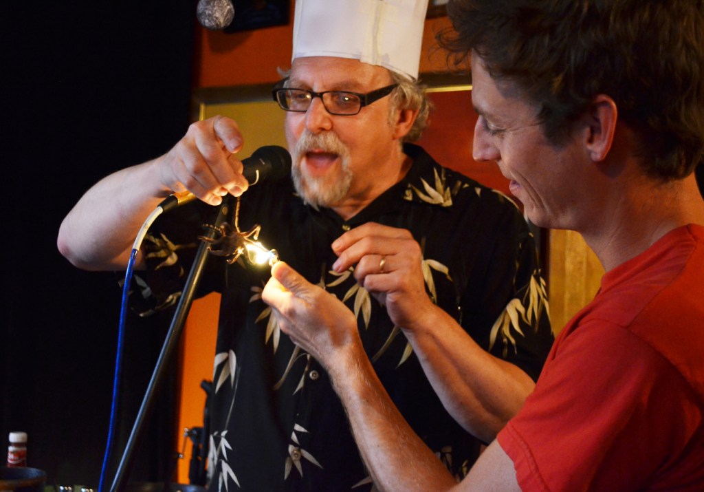 David Gorden singes the hair off a tarantula with help from Ben.