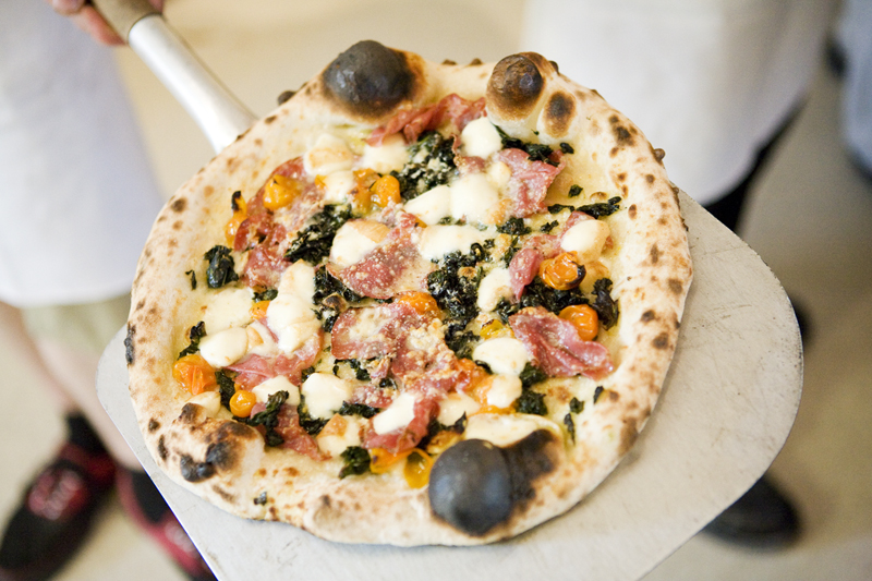 A Salami Piccante pizza with tomato, salame, mozzarella, roasted peppers and grana.