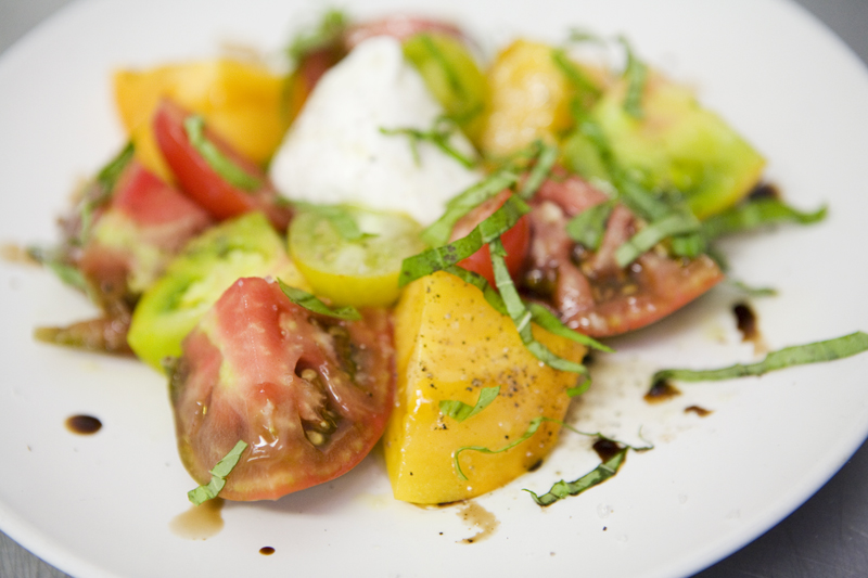 Heirloom tomatoes and burrata With extra virgin olive oil, balsamic must, basil and coarse sea salt.