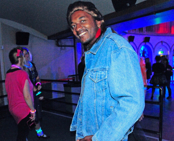 Alton Johnson, in mullett wig, is all smiles.