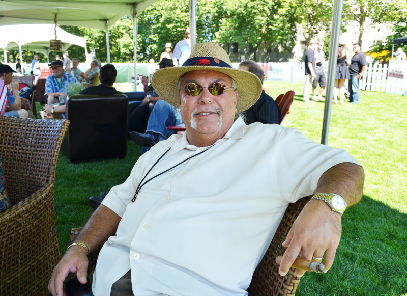 Bob Deveny enjoys conversation and cigars with his friends at the Expo.