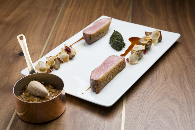 Thickly cut slabs of duck breastaE”one perfectly cooked, one badly overdoneaE”are laid in opposing, cherry-sauced rows, with hills of farro and chard set between.