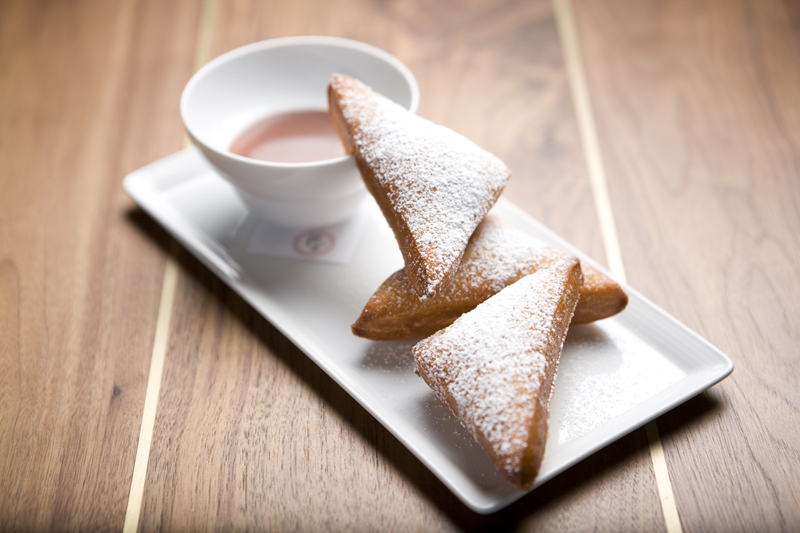 Much-touted beignets, paired with a supremely alcoholic butterscotch sauce layered with caramel, are dense and bland.