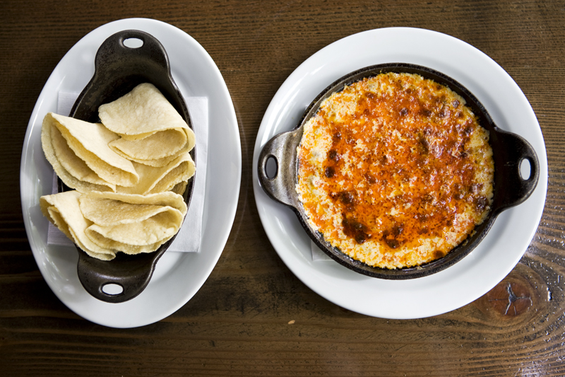 Golden melting cheese and chorizo dip with handmade tortillas at Poquitos.