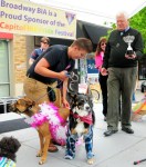 Congressman Jim McDermott awards the 2011 Doggie Drag show trophy to Danny Wakefield and Jersey and Brooklyn dressed as Butch and Femme.