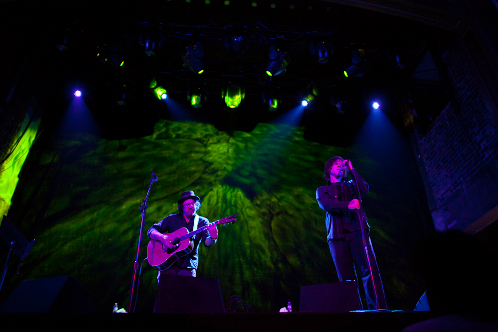 Bathed in purple, backed by green.