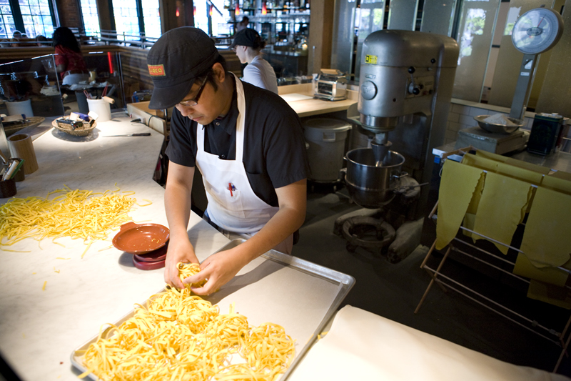 Herschel Taghap weighing portions of the pasta out.
