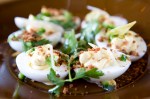 Deviled eggs, bacon crispies, and green garlic.