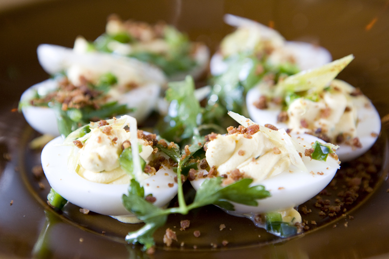 Deviled eggs, bacon crispies, and green garlic.