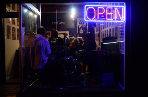 Like moths to a flame, the neon glow attracts late-night wanderers.