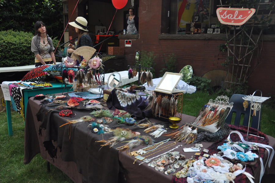 Beautiful handmade feather pendants and brooches for sale outside The In art collective on 17th and Olive.