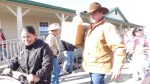 A member of the Kittitas County CattlemenaE™s Association helps a member of EllensburgaE™s Hispanic community carry a box of food to her car.