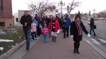 A diverse group of protestors make their way through downtown Ellensburg.