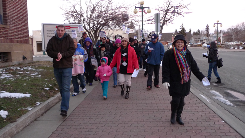 A diverse group of protestors make their way through downtown Ellensburg.