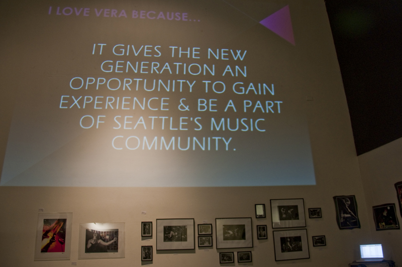 A live feed of reasons to love Vera is projected on the gallery wall above photographs of VeraaE™s history.