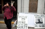 About a dozen protesters gathered today at the King County Courthouse in