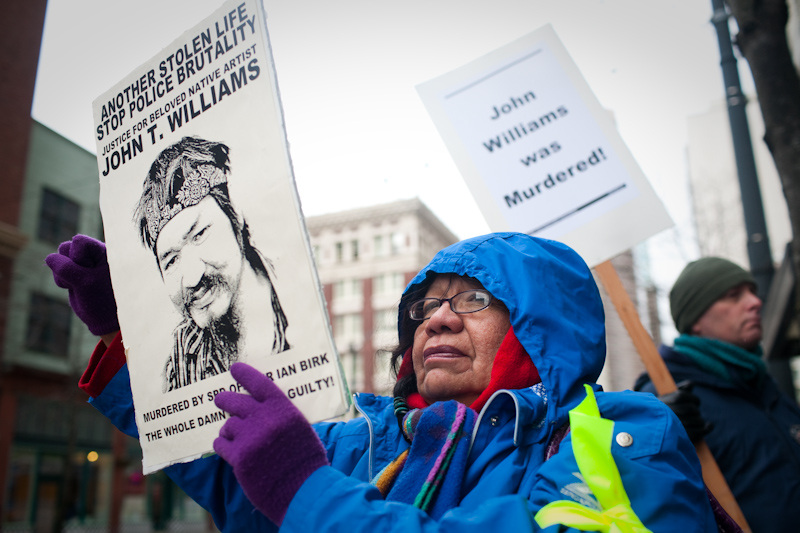 About a dozen protesters gathered today at the King County Courthouse in
