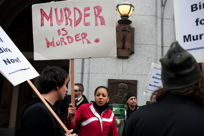 About a dozen protesters gathered today at the King County Courthouse in