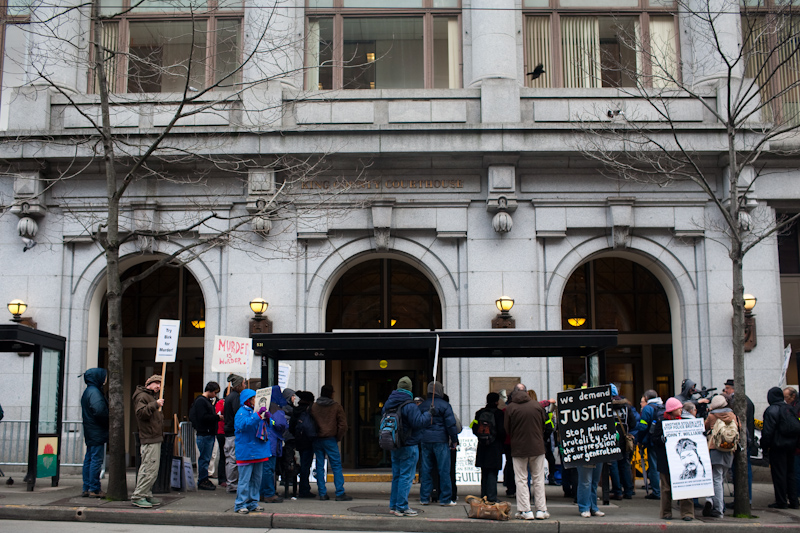 About a dozen protesters gathered today at the King County Courthouse in