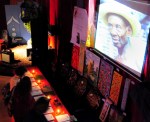 Haitian art is featured in a silent auction as a Haitian slide show plays overhead.