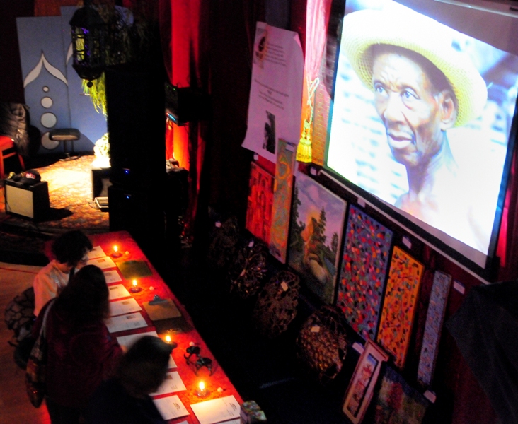 Haitian art is featured in a silent auction as a Haitian slide show plays overhead.