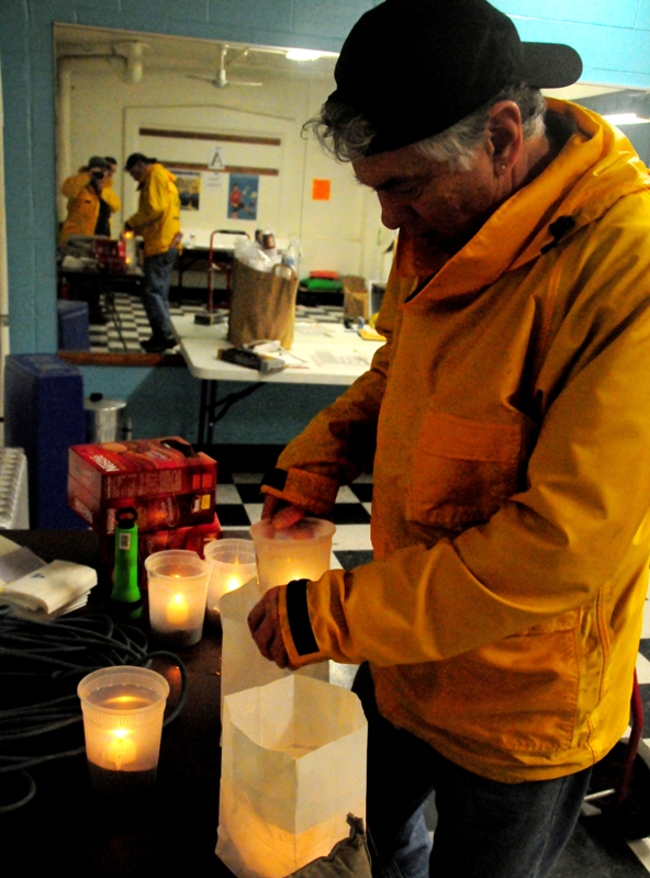 Jeff Skinner, Parks staff at Green Lake Community Center, tries a drier approach - light the candles indoors and then take them outside.