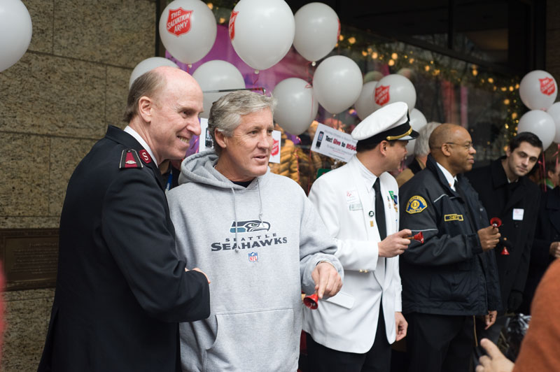 Salvation Army Lt. Colonel Doug O'Brien shakes hands with Seahawks coach Pete Carroll.