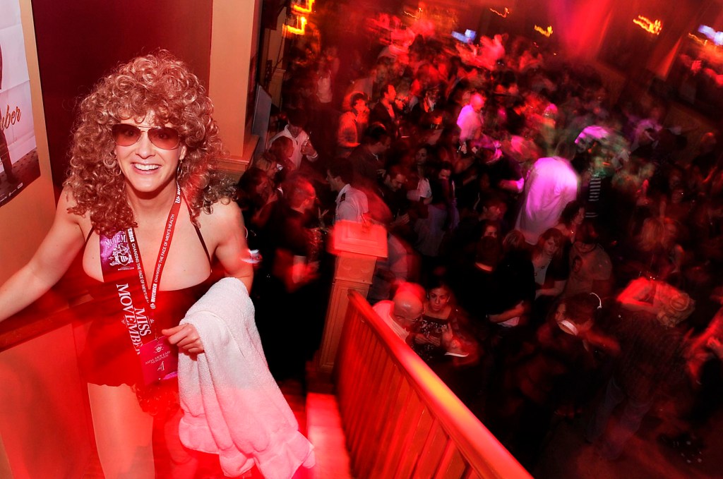 Reigning Miss Movember 2009 Heidi Hawkins of Seattle egresses from the dance floor at Trinity during the 2010 Movember Seattle Gala Parte on Saturday evening Nov. 27, 2010, in Pioneer Square in downtown Seattle. Movember is a charity event that originated in Australia in 2003 and is growing exponentially throughout the world. As part of the fundraising challenge, men grow a mustache beginning November 1st to help raise funds for prostate and testicular cancer research. The funds go to the Livestrong Foundation and also for prostate cancer research.